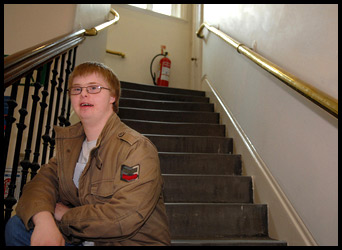 Teenage boy sat on staircase