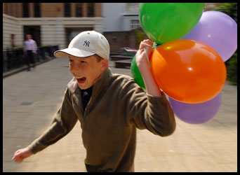 Boy running with balloons